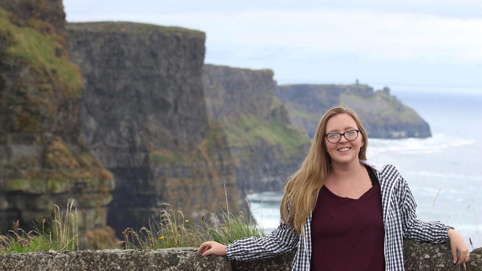 Student Chloe Harrison in front of the cliffs of Moher.
