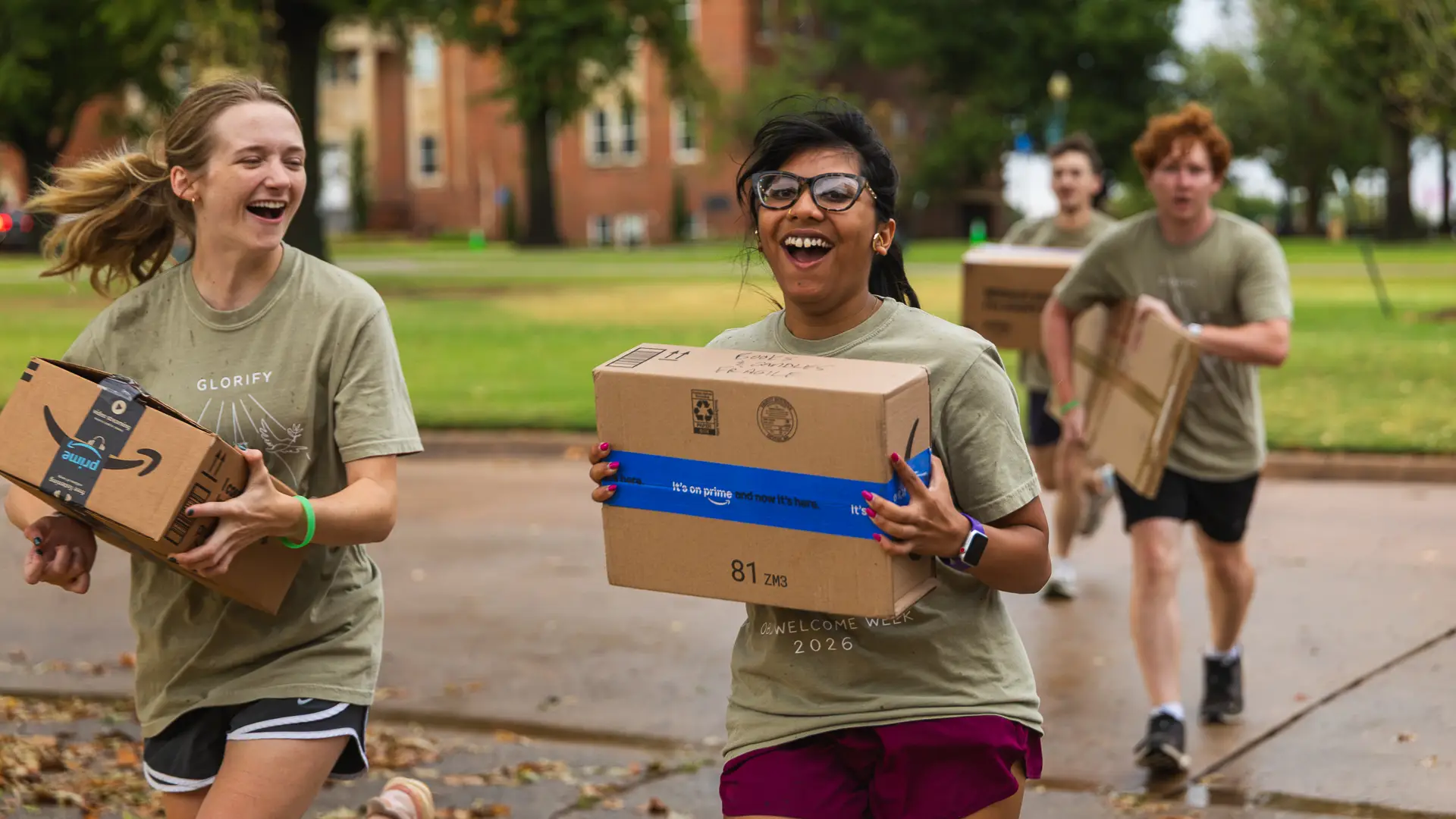 Upperclassmen volunteers assist students with unloading vehicles and moving belongings into residence halls across campus.