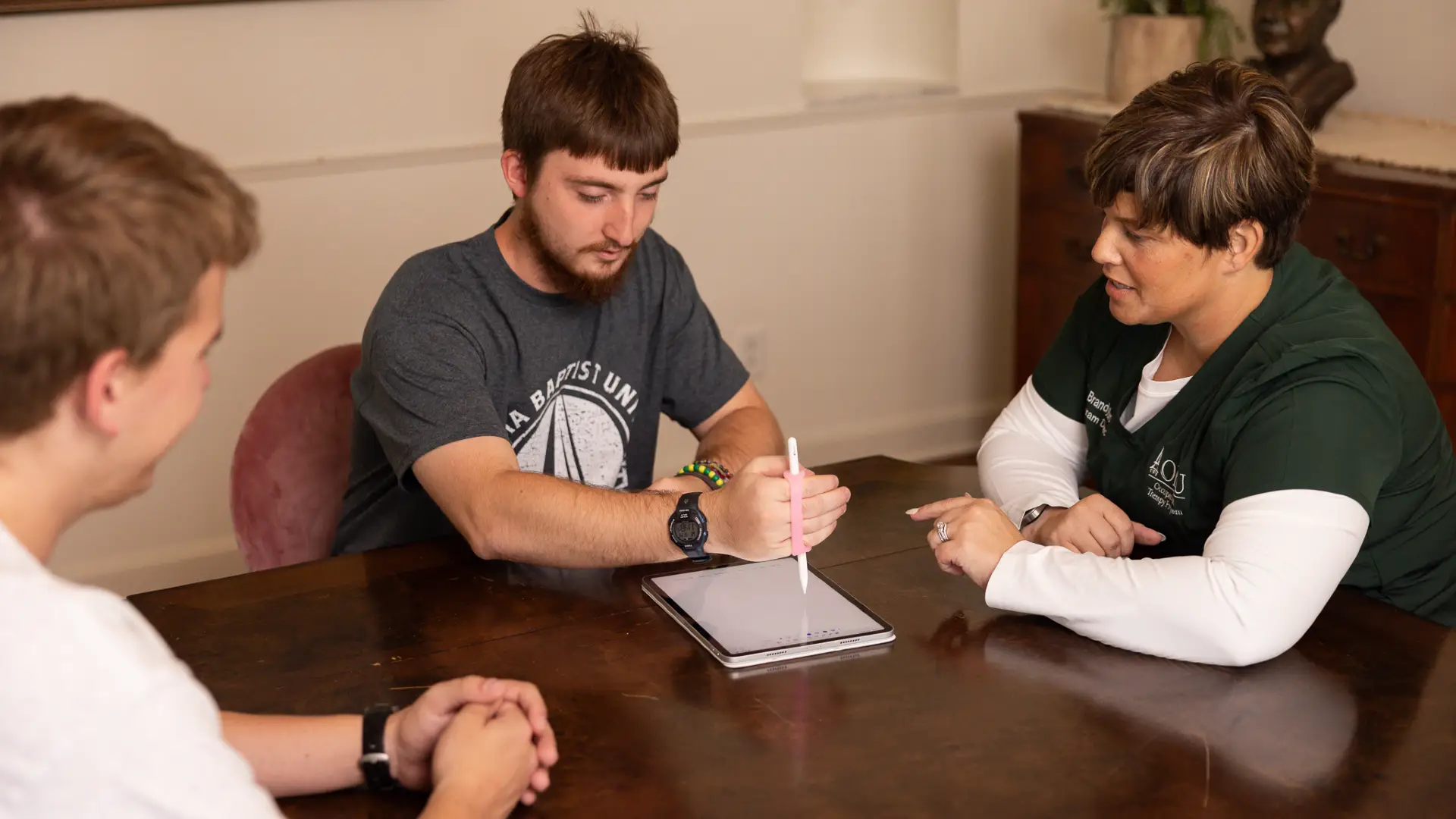 Dr. brown teaching students how to help patients write after injury.