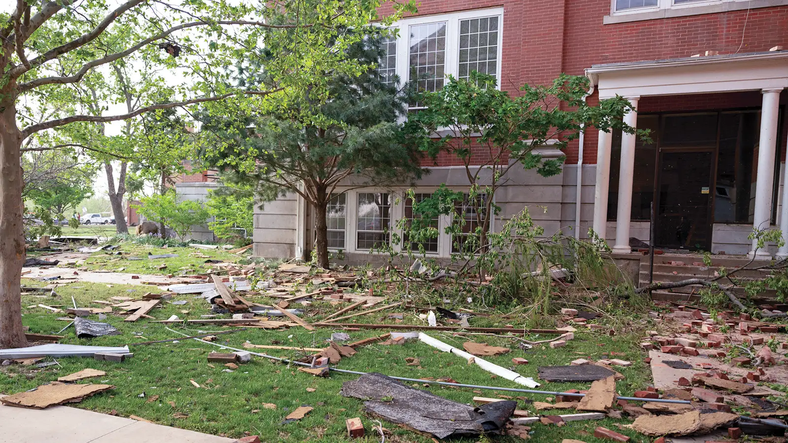 Debris is scattered on the ground outside Shawnee Hall