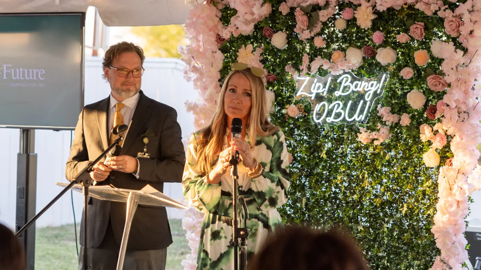 Jill and Heath Thomas talking under tent