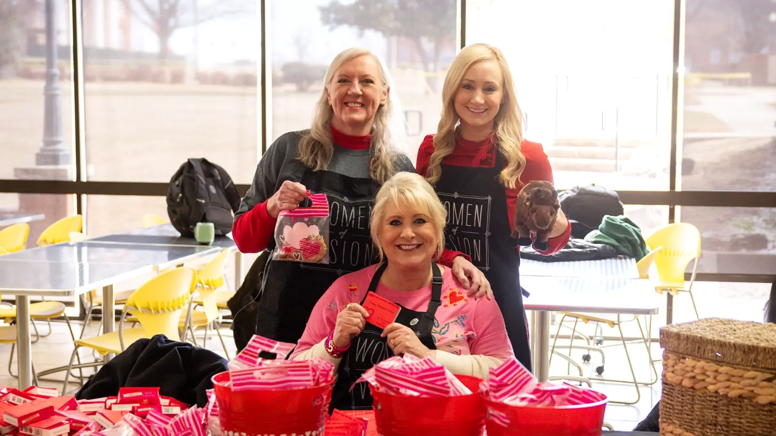 women of vision passing out valentine candy