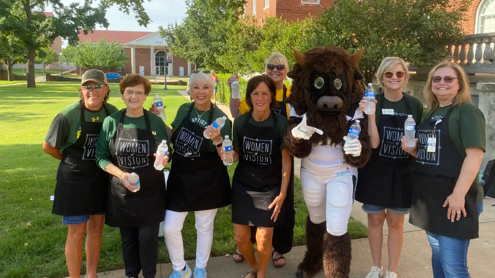 women of vision passing out water